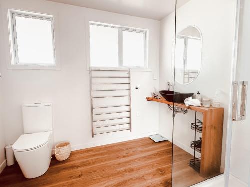 a bathroom with a toilet and a glass shower at Two One Two in Hokitika