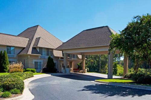 a house with a driveway in front of it at Baymont Inn & Suites Braselton in Braselton