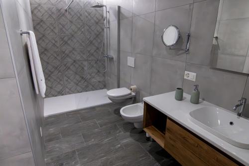 a bathroom with a toilet and a sink and a shower at Albergo Stazione in Bodio