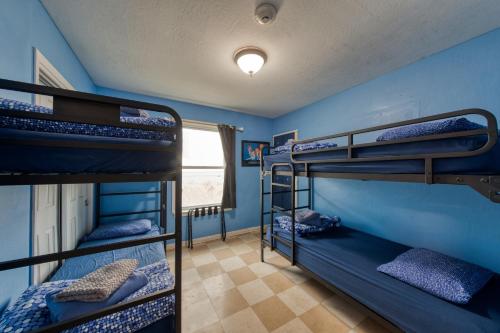 two bunk beds in a room with blue walls at HI Point Montara Lighthouse in Montara