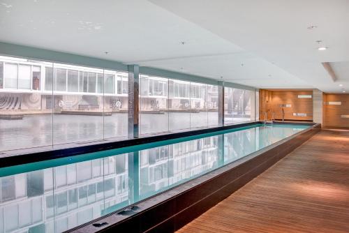 a swimming pool in the middle of a building at Pool-bikes-escooter! 2bed central in Auckland