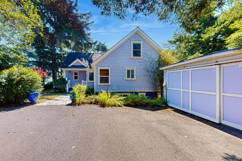 a blue house with a white garage at Blue Heron Bluff in Newport