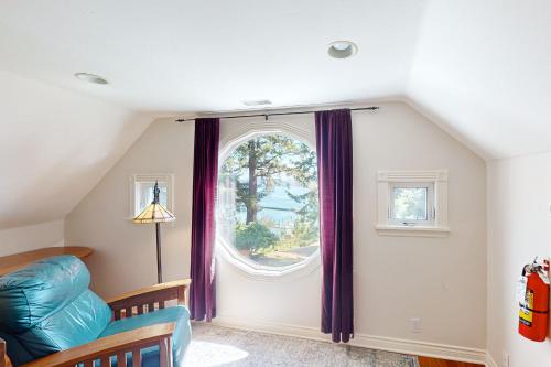 a room with a large window with purple curtains at Blue Heron Bluff in Newport