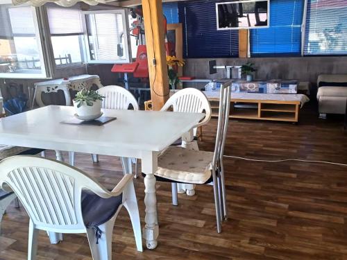 a white table and chairs in a room at Apartment - MY DESTINATION in Slavonski Brod