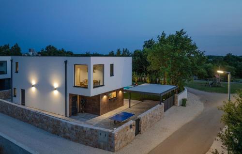 a house with a tennis court on top of it at Amazing Home In Modrusani With Sauna in Modrušani