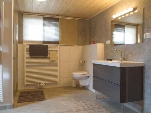 a bathroom with a sink and a toilet in it at Landhaus am See - Obertraun - Salzkammergut in Obertraun