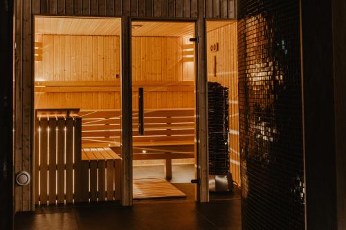 a sauna with wooden benches in a room at Apartamenty Na Wzgórzu in Świeradów-Zdrój