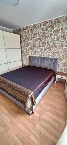 a bed in a room with a brick wall at Roberto dangaus apartamentai in Vilnius