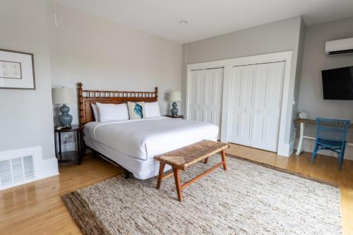 a bedroom with a bed and a table and a tv at The Newport Lofts - 194 Thames Street in Newport