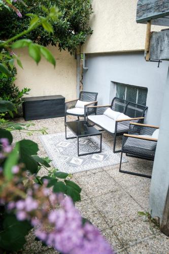 a patio with two chairs and a table at Lake Life in Sankt Gilgen