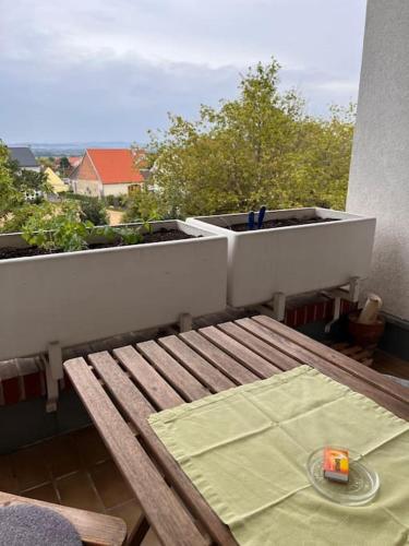 a wooden bench sitting on top of a balcony at Appartment Weitblick in Eisenstadt