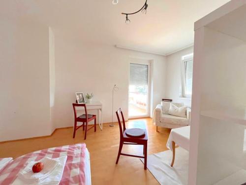 a living room with a bed and a table and chairs at Appartment Weitblick in Eisenstadt