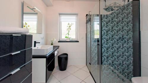 a bathroom with a shower and a sink at Przystanek Przywidz in Trzepowo