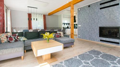 a living room with a couch and a fireplace at Przystanek Przywidz in Trzepowo