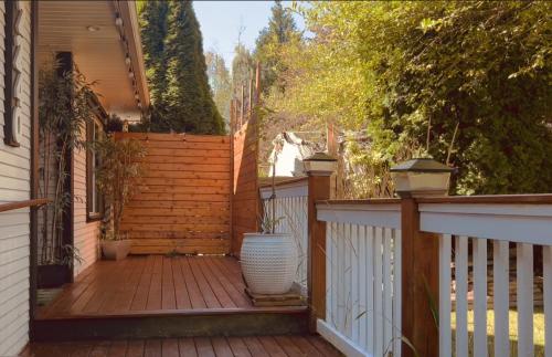 a porch with a white fence and a white vase at Airport-YVR GuestHouse in Richmond