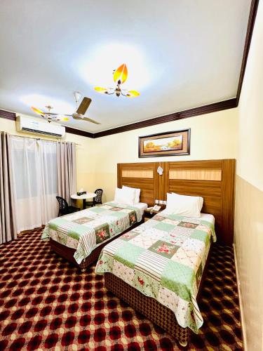 a hotel room with two beds in a room at Al Ahrar Hotel in Dubai