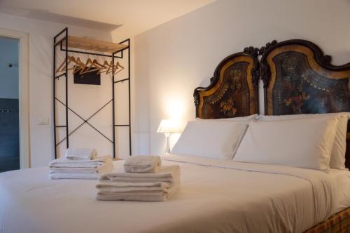 a bedroom with a bed with towels on it at Vittorio Emanuele Suite Apartment in Palermo