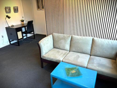 a living room with a white couch and a table at BB Ikast in Ikast