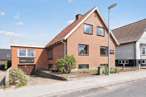 a brick house on the side of a street at BB Ikast in Ikast