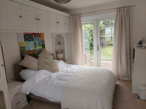 a bedroom with a white bed and a window at 210 Greenlea Court in Kirkheaton