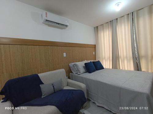 a hotel room with a bed and a couch at Apto Praia Intermares Cabedelo Paraiba Q208 in Nossa Senhora do Livramento