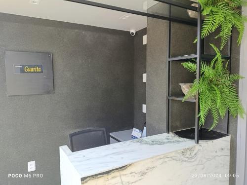 an office with a desk with a plant on it at Apto Praia Intermares Cabedelo Paraiba Q208 in Nossa Senhora do Livramento