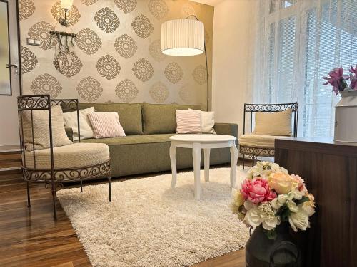 a living room with a couch and a table and chairs at Villa Stella in Prešov