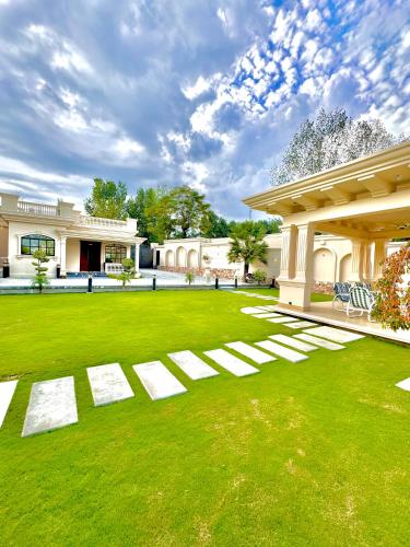 a large yard with white steps in front of a building at Emerald Villa Swat in Ghurejo