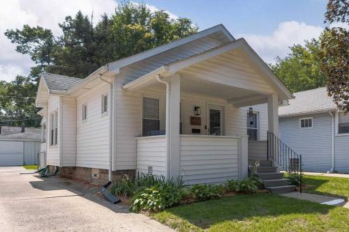 a small white house with a porch at Hip Historic Home In Downtown Ferndale in Ferndale