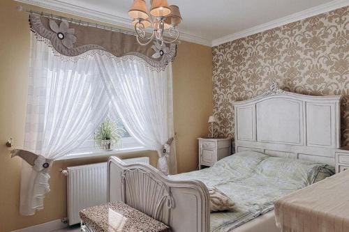 a bedroom with a white bed and a window at Holiday Home Ko czewo near Lakes and Forests in Kołczewo
