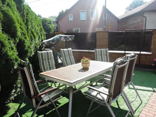 a wooden table and chairs on a patio at Holiday Home Ko czewo near Lakes and Forests in Kołczewo