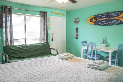 a bedroom with a bed with two towels on it at Pool with Canal views Minutes 2 beach BBQ Pit in Padre Island