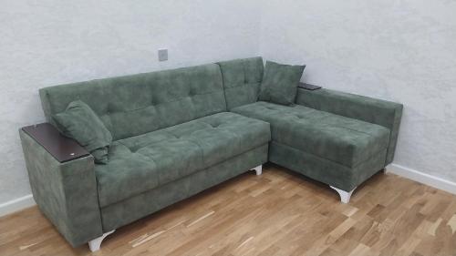 a green couch sitting in a living room at Banu House in Sumqayyt