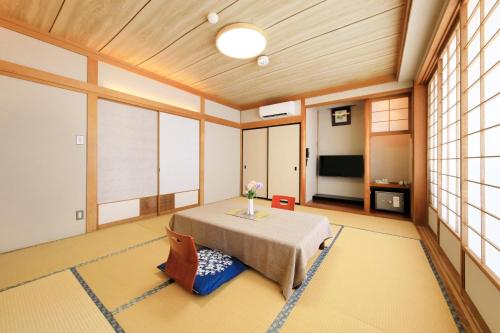 a large room with a table and some windows at Ocean View Hiromi SPA Hotel温泉と絶景の宿 in Shimoda