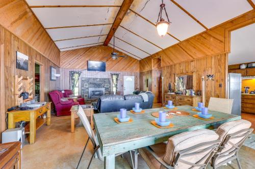 a dining room and living room with a table and chairs at Rural Arkansas Vacation Rental with Lake Access in Scranton