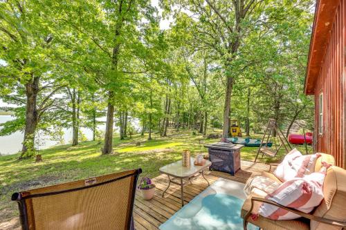 a deck with a table and chairs and a grill at Rural Arkansas Vacation Rental with Lake Access in Scranton