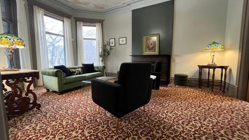 a living room with a couch and a fireplace at Stone Gables Inn in Cleveland