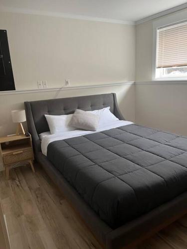a bed in a white room with a bed sidx sidx sidx at Michaud's Basement unit in Nakusp
