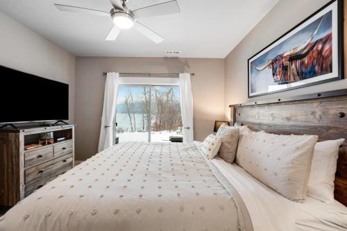 a bedroom with a large bed and a television at Whitefish Lake Wonder in Whitefish