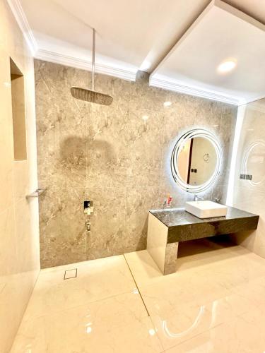 a bathroom with a sink and a mirror at Emerald Villa Swat in Ghurejo