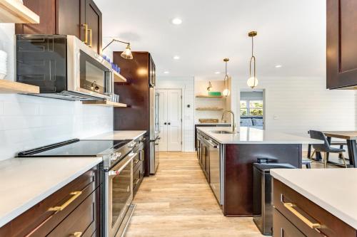 a large kitchen with wooden floors and stainless steel appliances at Family Tides by Sea Scape Properties in Wrightsville Beach