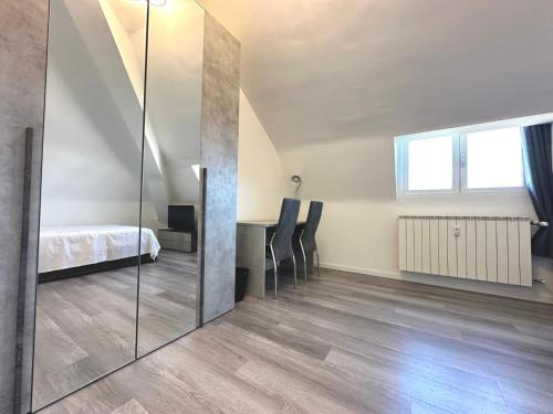 a bedroom with a bed and a mirror in a room at House Crocetta in Milan