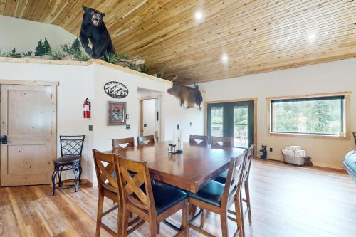 a dining room with a large wooden table and chairs at Bear Butte Retreat in Deadwood