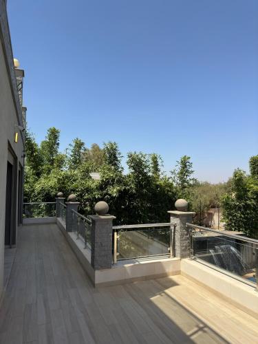 a balcony of a building with a view of trees at Villa luxueuse Marrakech Ourika in Ourika