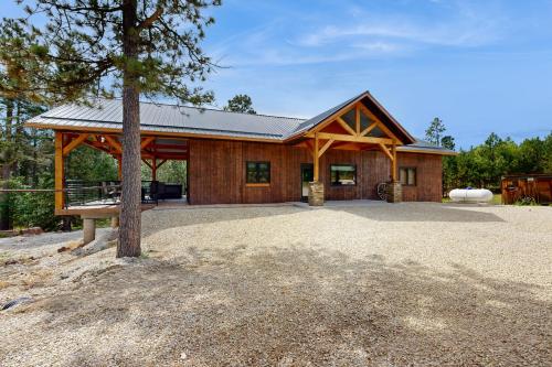 a large wooden house with a tree in front of it at Bear Butte Hideaway in Deadwood