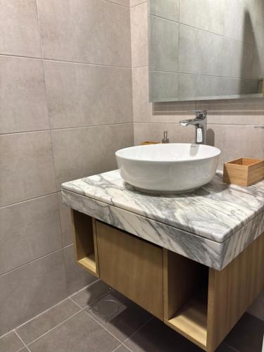 a bathroom with a white sink and a mirror at Business Bay Retreat in Dubai