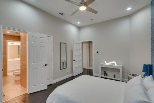 a white bedroom with a bed and a ceiling fan at Prestigious 5BR 3,5BA Holiday Home with Pool, Sauna, Game Room & Bar in Sachse