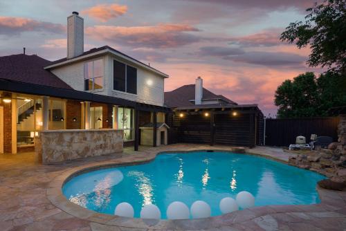 a swimming pool in front of a house at Prestigious 5BR 3,5BA Holiday Home with Pool, Sauna, Game Room & Bar in Sachse