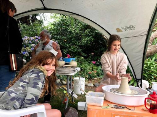 a group of people in a tent making pottery at Charming Spacious Rural Otaki Retreat in Otaki