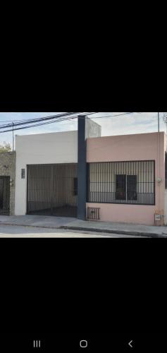 a building with two garage doors on a street at Habitación en Monterrey Centro in Monterrey
